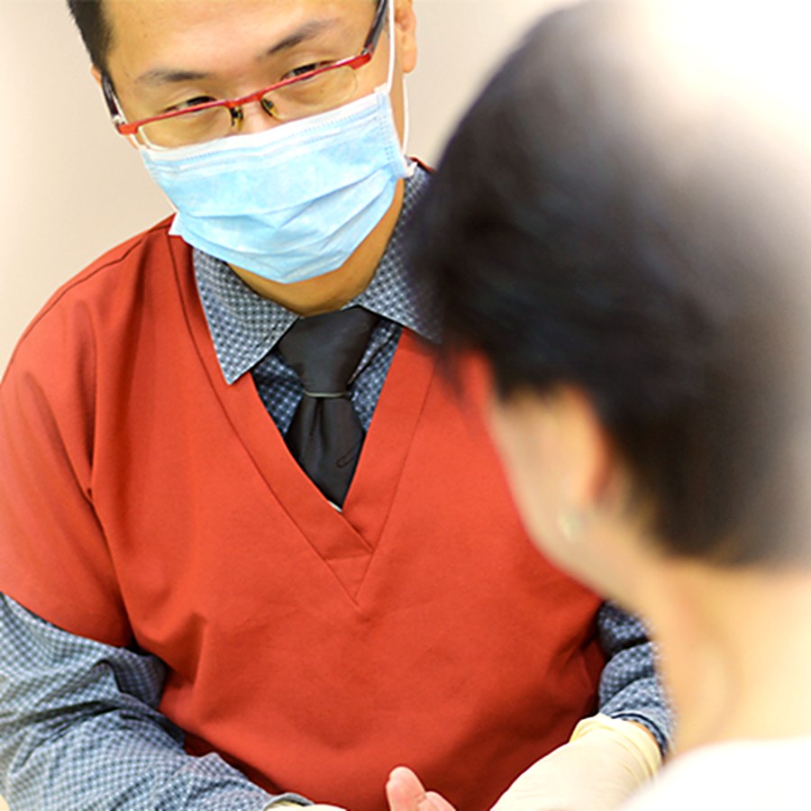 Dr Gerald Tan consulting with a patient at Frances Medical & Aesthetic Clinic